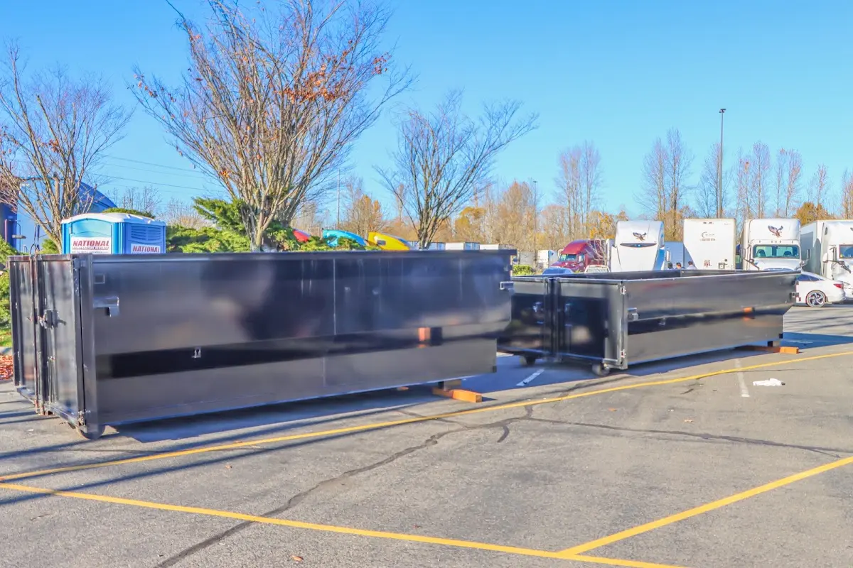 Professional dumpster rental service with roll-off container on residential driveway in Martins Ferry